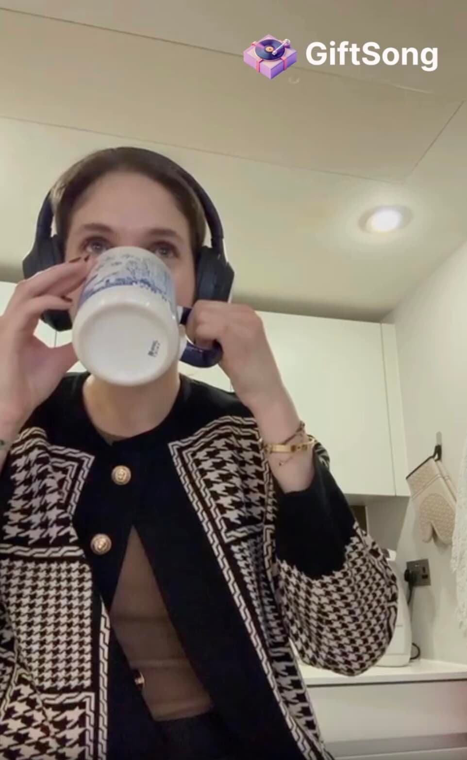 A listener holding a cup while hearing a personal song preview
